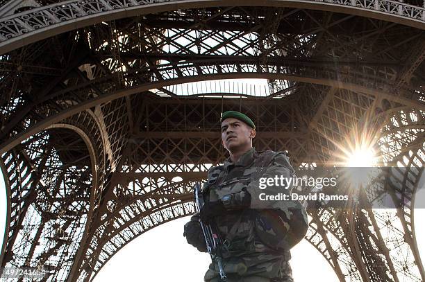 French soldier stands guard at Eiffel Tower on November 15, 2015 in Paris, France. As France observes three days of national mourning members of the...