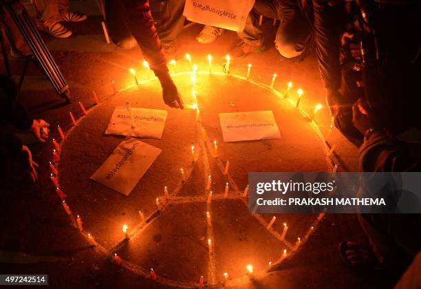 Nepalese people take part in a candle light vigil for the victims of the deadly attacks in Paris, in Kathmandu on November 15, 2015. Islamic State...
