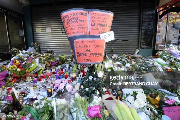 This photo taken on November 15, 2015 shows flowers, candles and messages left as a memorial outside of La Belle Equipe bar, in the 11th district of...