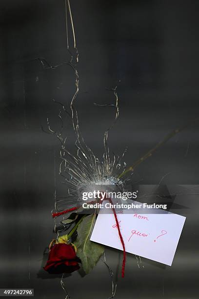 Rose is placed beside a bullet hole at La Belle Equipe restaurant on Rue de Charonne following Fridays terrorist attack on November 15, 2015 in...