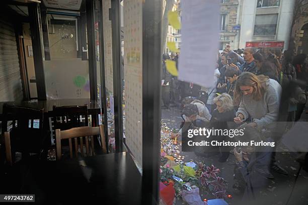 People place tributes and flowers outside La Belle Equipe restaurant on Rue de Charonne following Fridays terrorist attack and France observes three...