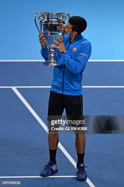 Serbia's Novak Djokovic kisses the trophy of the ATP World No 1 Award after it was presented to him following his men's singles group stage match...