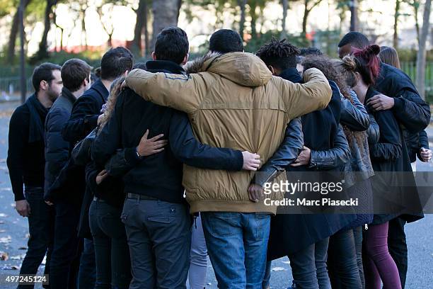 Friends reunite in memory of a victim near 'Le Bataclan' theatre on Boulevard Voltaire following Fridays terrorist attack and France observes three...