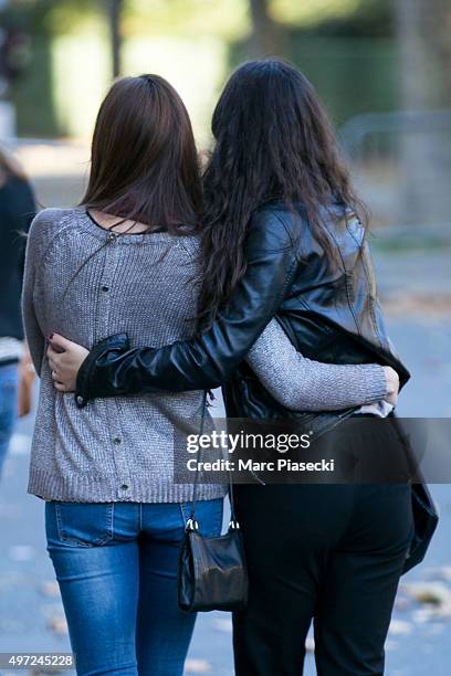 Friends reunite in memory of a victim near 'Le Bataclan' theatre on Boulevard Voltaire following Fridays terrorist attack and France observes three...