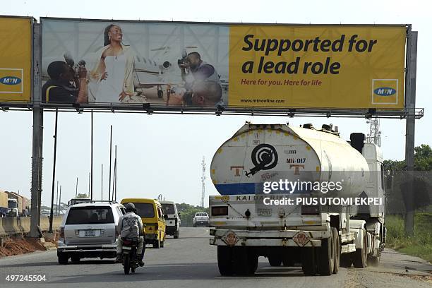 Motorists drive past a MTN billboard across Lagos-Ibadan expressway on November 15, 2015. South African mobile giant MTN has tomorrow deadline to pay...