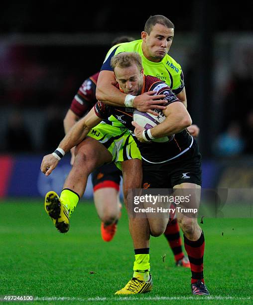 Sarel Pretorius of Newport Gwent Dragons is tackled by Mark Jennings of Sale Sharks during the European Rugby Challenge Cup match between Newport...