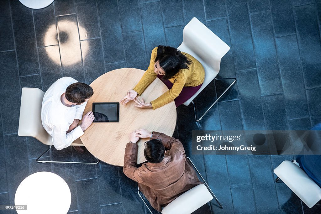 Business people meeting in modern office, view from above