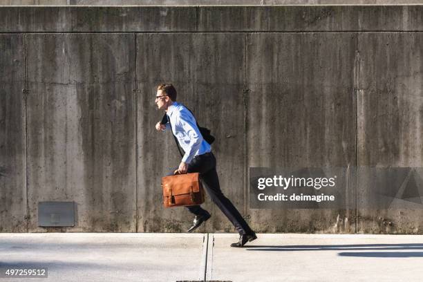 businessman running with briefcase - breaking through wall stockfoto's en -beelden