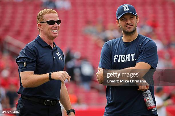 Head coach Jason Garrett and Tony Romo of the Dallas Cowboys looks on during a game against the Tampa Bay Buccaneers at Raymond James Stadium on...