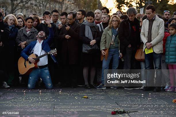 Man sing the song Hallelujah as people pause for thought at Place de la Republique as France observes three days of national mourning for the victims...