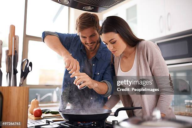 spicing things up - young couple cooking stock pictures, royalty-free photos & images