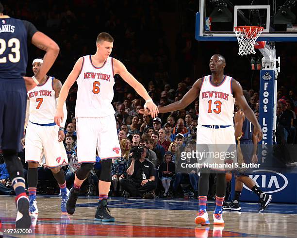 Kristaps Porzingis high fives Jerian Grant of the New York Knicks during the game against the New Orleans Pelicans on November 15, 2015 at Madison...