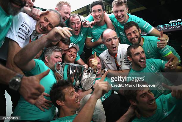 Nico Rosberg of Germany and Mercedes GP celebrates his victory with team mates during the Formula One Grand Prix of Brazil at Autodromo Jose Carlos...