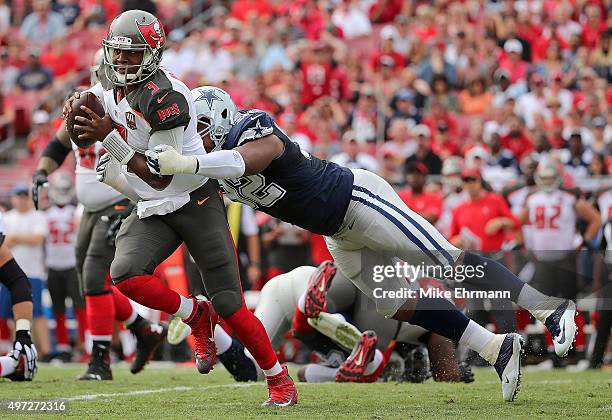 Jameis Winston of the Tampa Bay Buccaneers escapes a tackle from Jeremy Mincey of the Dallas Cowboys during a game at Raymond James Stadium on...