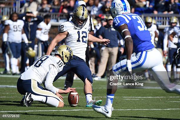 Chris Blewitt of the Pittsburgh Panthers kicks for an extra point from the hold of Ryan Winslow against the Duke Blue Devils at Wallace Wade Stadium...