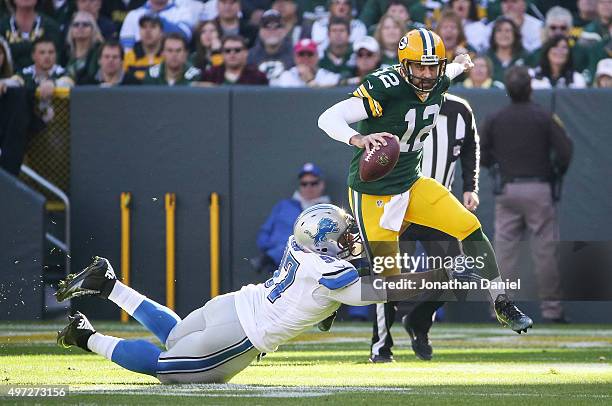 Quarterback Aaron Rodgers of the Green Bay Packers is sacked by Caraun Reid of the Detroit Lions in the first quarter at Lambeau Field on November...