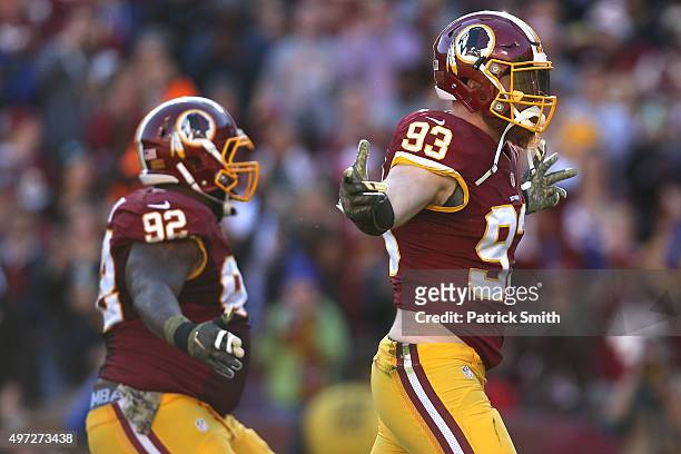 Outside linebacker Trent Murphy of the Washington Redskins celebrates a sack with teammate Chris Baker against the New Orleans Saints in the second...