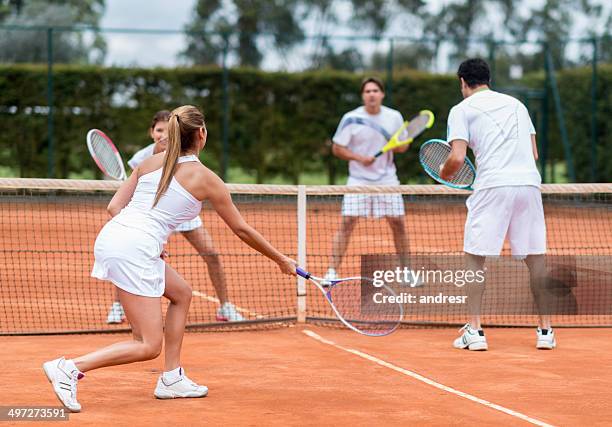 friends playing tennis - mixed doubles stockfoto's en -beelden