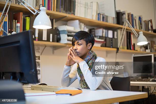 concentrating on new business project - black woman computer programmer stock pictures, royalty-free photos & images