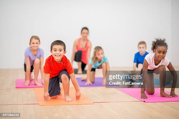 children doing pilates together - family yoga stock pictures, royalty-free photos & images