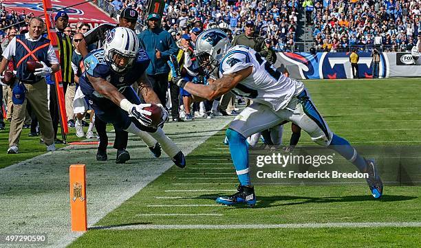 Dexter McCluster of the Tennessee Titans dives towards the pilon to score a touchdown against Kurt Coleman of the Carolina Panthers during the first...