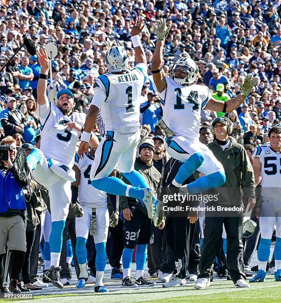 Derek Anderson,Cam Newton, and Joe Webb of the Carolina Panthers celebrate after a touchdown against the Tennessee Titans during the first half at...