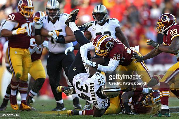 Running back Tim Hightower of the New Orleans Saints is tackled by cornerback Deshazor Everett of the Washington Redskins in the fourth quarter at...