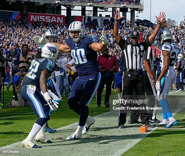 Anthony Fasano of the Tennessee Titans congratulates teammate Dexter McCluster on scoring a touchdown against the Carolina Panthers during the first...