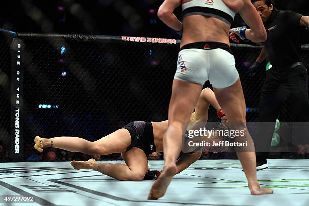 Ronda Rousey falls to the mat as she is knocked out by Holly Holm in their UFC women's bantamweight championship bout during the UFC 193 event at...