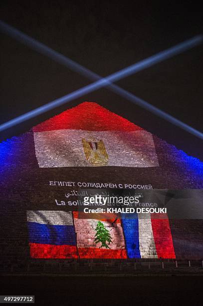 The great pyramid of Khufu is illuminated with the French, Lebanese and Russian flags in Giza, outskirt of Cairo on November 15 during a ceremony in...