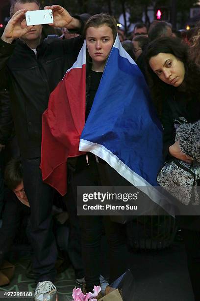 Mourners pay their respects near the "Bataclan" on November 15, 2015 in Paris, France. As France observes three days of national mourning members of...