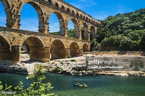 kayak on the gardon river - pont du gard aqueduct stock pictures, royalty-free photos & images
