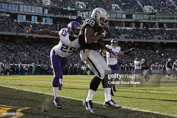 Tight end Clive Walford of the Oakland Raiders scores a touchdown in the second quarter in front of cornerback Xavier Rhodes of the Minnesota Vikings...