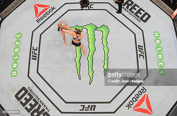 An overhead view of the Octagon as Holly Holm punches Ronda Rousey in their UFC women's bantamweight championship bout during the UFC 193 event at...