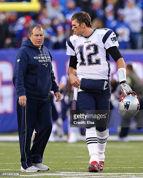 Tom Brady of the New England Patriots speaks with head coach Bill Belichick prior to the game against the New York Giants at MetLife Stadium on...