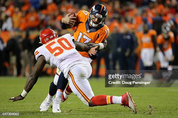 Quarterback Brock Osweiler of the Denver Broncos is sacked by linebacker Justin Houston of the Kansas City Chiefs in the fourth quater at Sports...