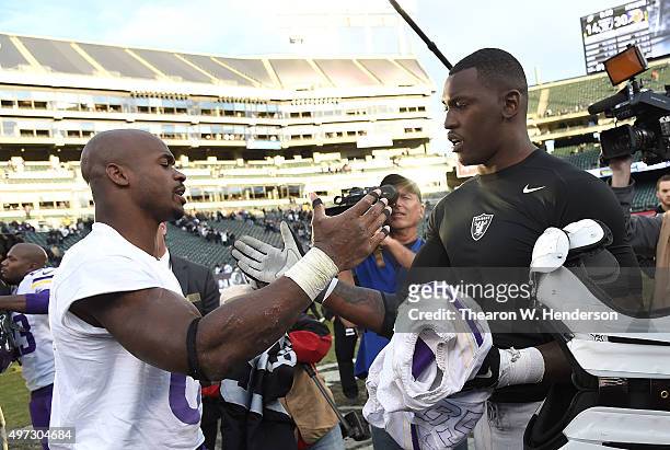 Running back Adrian Peterson of the Minnesota Vikings exchanges jerseys with outside linebacker Aldon Smith of the Oakland Raiders after the end of...
