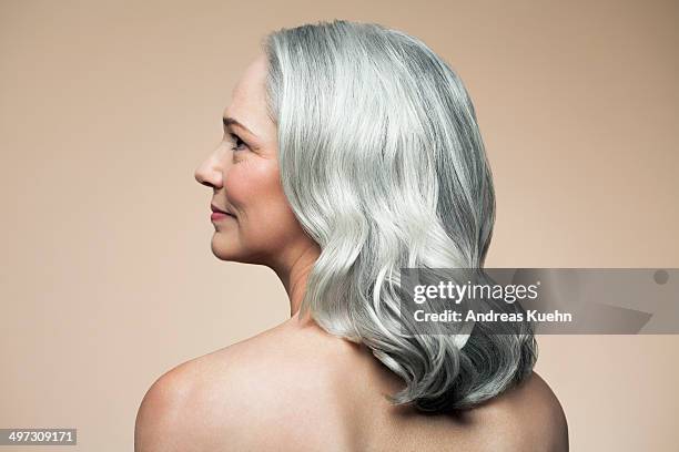 mature woman with grey hair, rear view profile. - cabello gris fotografías e imágenes de stock