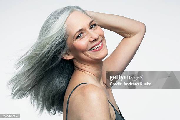 woman with grey hair and big smile, portrait. - hand in hair stock pictures, royalty-free photos & images