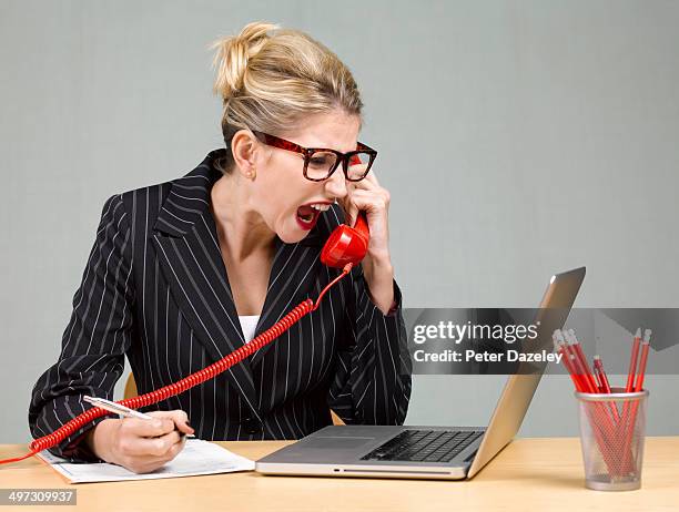 angry businesswoman at desk - angry woman red stock pictures, royalty-free photos & images