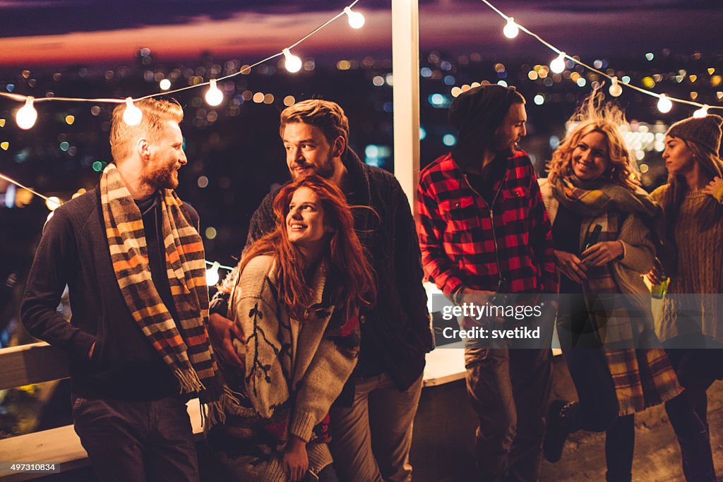 Group of friends at rooftop party