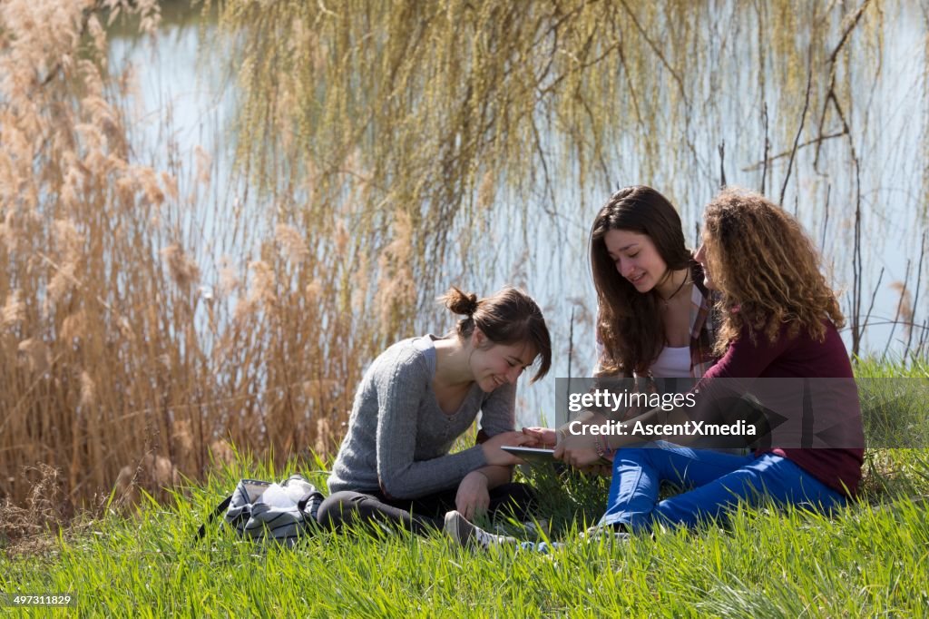 Teenage girls relaxing in field