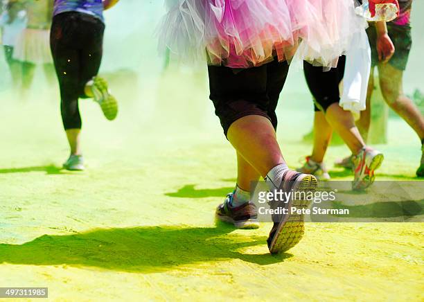color run competitors in costume - color run foto e immagini stock