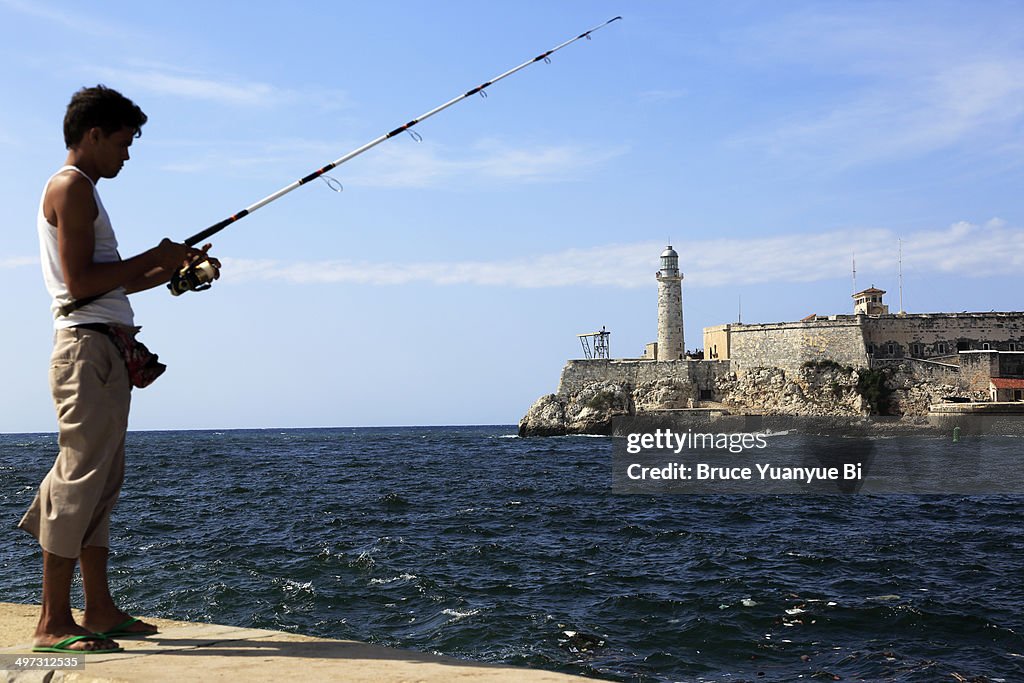 Morro Castle with a young man fishing