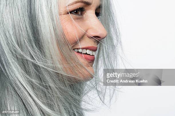 smiling grey haired woman, profile. - capelli grigi foto e immagini stock