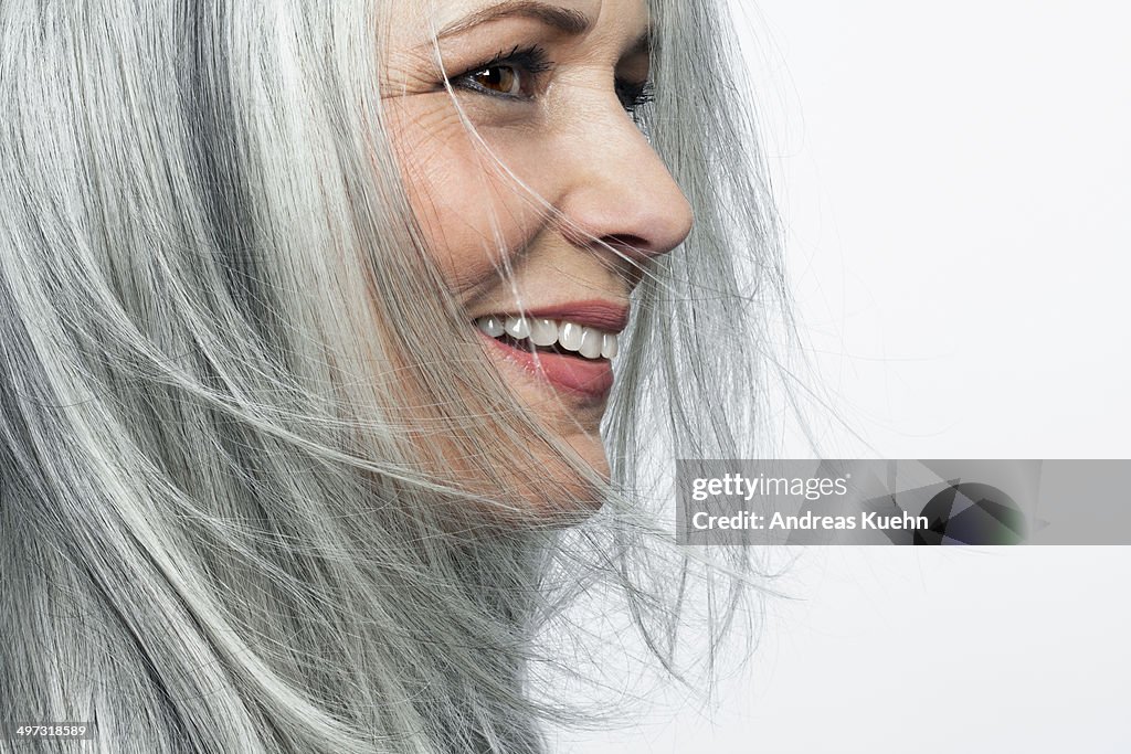 Smiling grey haired woman, profile.