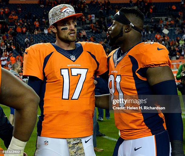 Quarterback Brock Osweiler of the Denver Broncos chats with defensive end Kenny Anunike of the Denver Broncos after the Broncos were defeated by the...