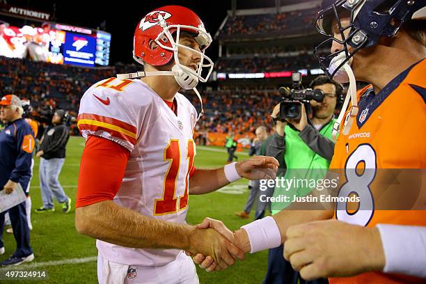 Quarterback Alex Smith of the Kansas City Chiefs shakes hands with quarterback Peyton Manning of the Denver Broncos after their game at Sports...