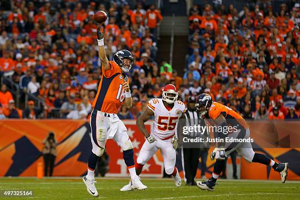 Quarterback Peyton Manning of the Denver Broncos throws a pass during the third quarter in front of linebacker Dee Ford of the Kansas City Chiefs and...
