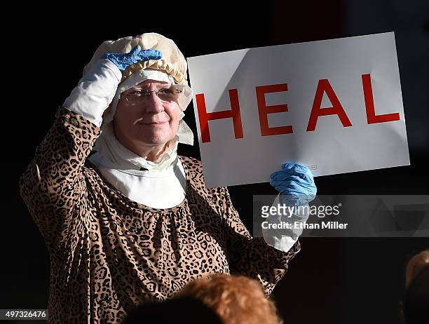 Bettie Robertson of Nevada holds a sign as she waits to see Republican presidential candidate Ben Carson speak during a campaign rally at the...